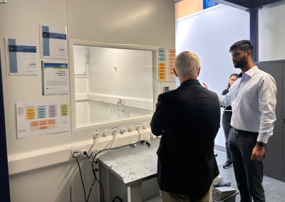 Dennis Knight and Oliver Dsa looking into a sealed test chamber at Airmid Healthgroup.
