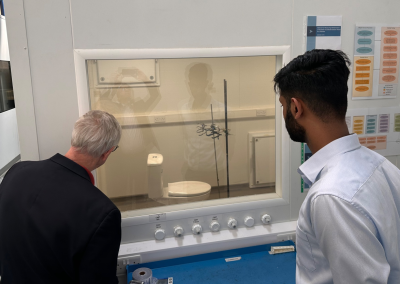 ASHRAE President observing a sealed test chamber simulating infectious toilet plumes in a hospital setting.