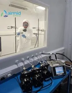 Infectious Aerosol Testing at Airmid Healthgroup Scientist conducting infectious aerosol testing inside Airmid Healthgroup’s bioaerosol chamber