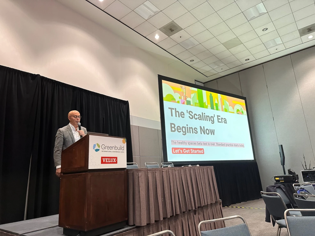 Keynote speaker introduces the idea that the beta test for healthy buildings is over and the scaling era for standard practice has begun.
