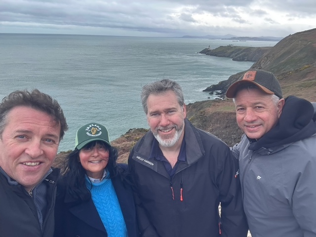 ASHRAE President Bill McQuade, ASHRAE Region XIV Director and Regional Chair Mahroo Eftekhari, ASHRAE Ireland President Howard Neville, and Dr. John McKeon stand together on the Howth cliff path overlooking the Irish Sea and Atlantic coastline near Dublin.