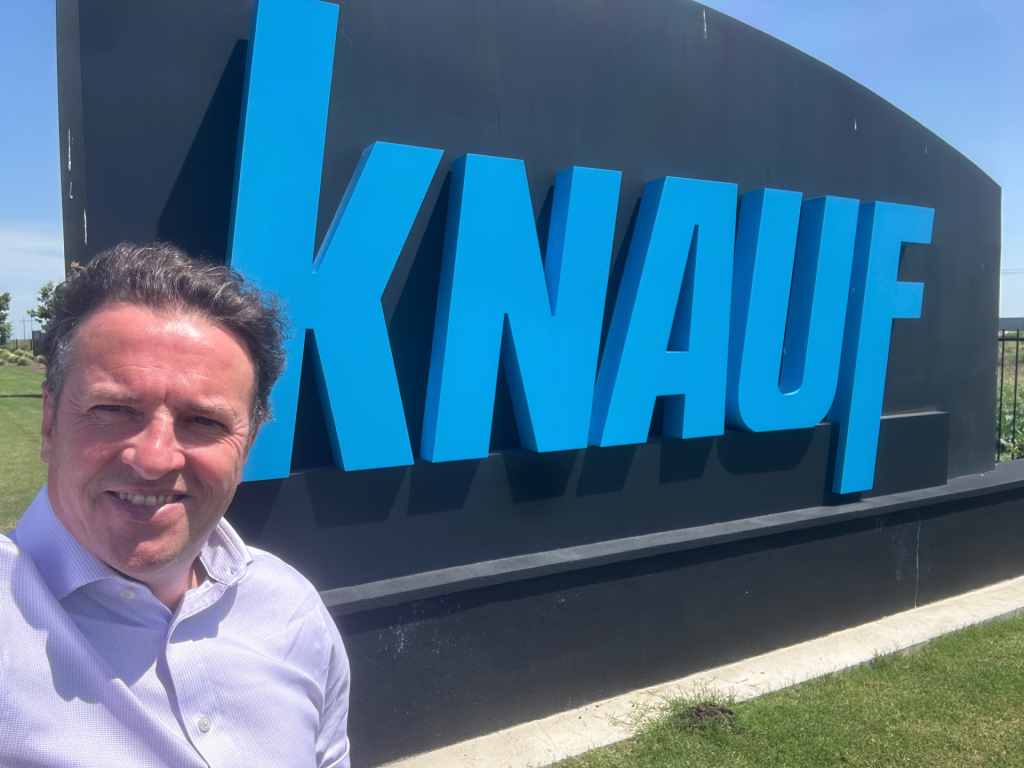 Dr John McKeon at Knauf McGregor Texas Facility | Airmid Healthgroup Dr. John McKeon of Airmid Healthgroup, indoor air quality testing lab, at the Knauf McGregor Texas facility entrance sign